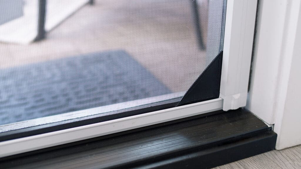 Detail of Phantom Retractable Screen door seamlessly integrated into a coastal-style California home.