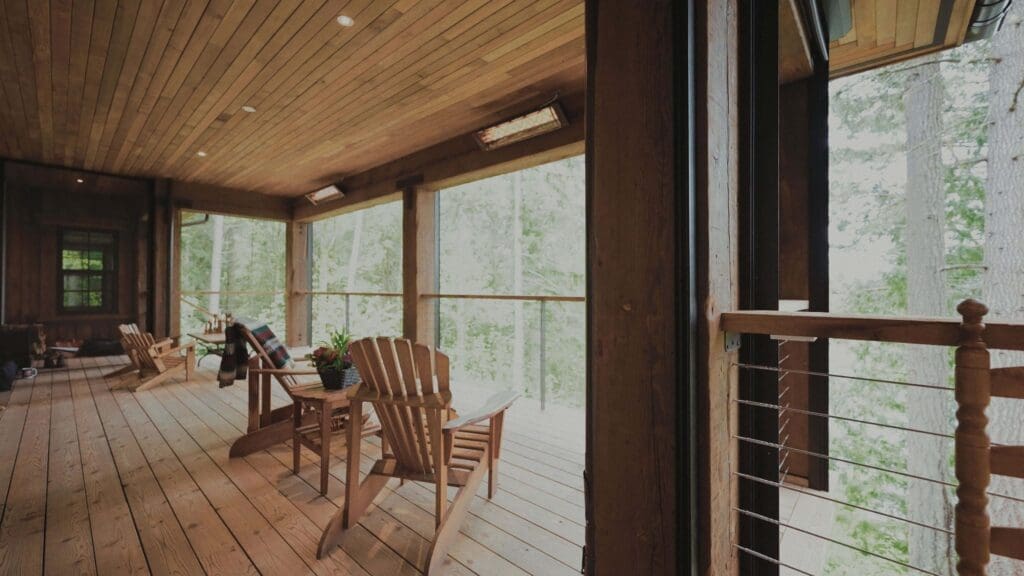 Outside view of porch with Phantom Screen door closed, blending seamlessly with the home’s rustic design.