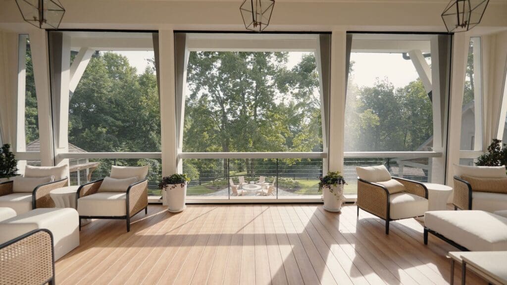 Southern style home design with interior view of balcony through fully deployed Phantom Screens, showcasing seamless indoor-outdoor connection.