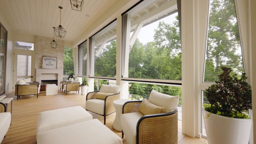 Homeowner using a Phantom Screens Somfy remote to lower motorized screen on a sunny Southern California day.