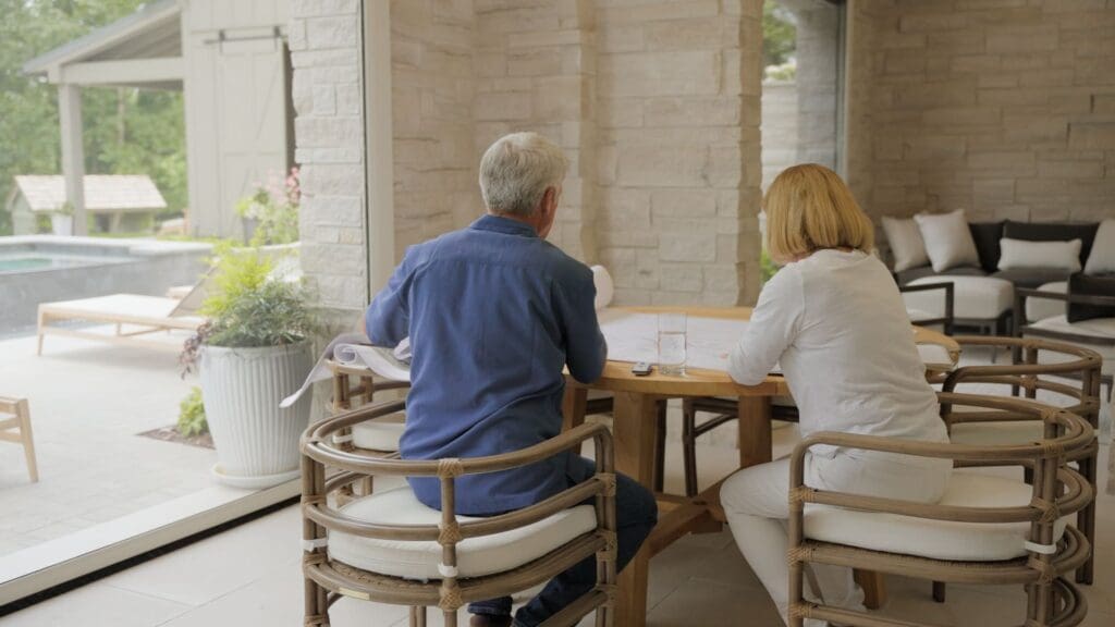Couple enjoying a bug-free patio meal with fully deployed Phantom Screens in Beverly Hills home.
