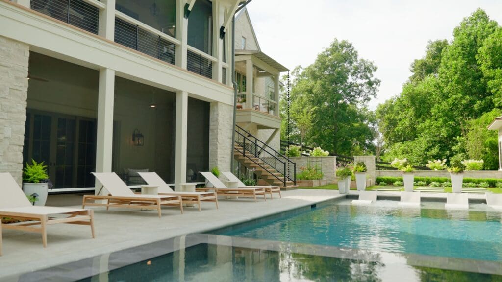 Luxury backyard with pool and fully deployed Phantom Screens enclosing the patio in Laguna Beach, delivering premium outdoor bug protection.