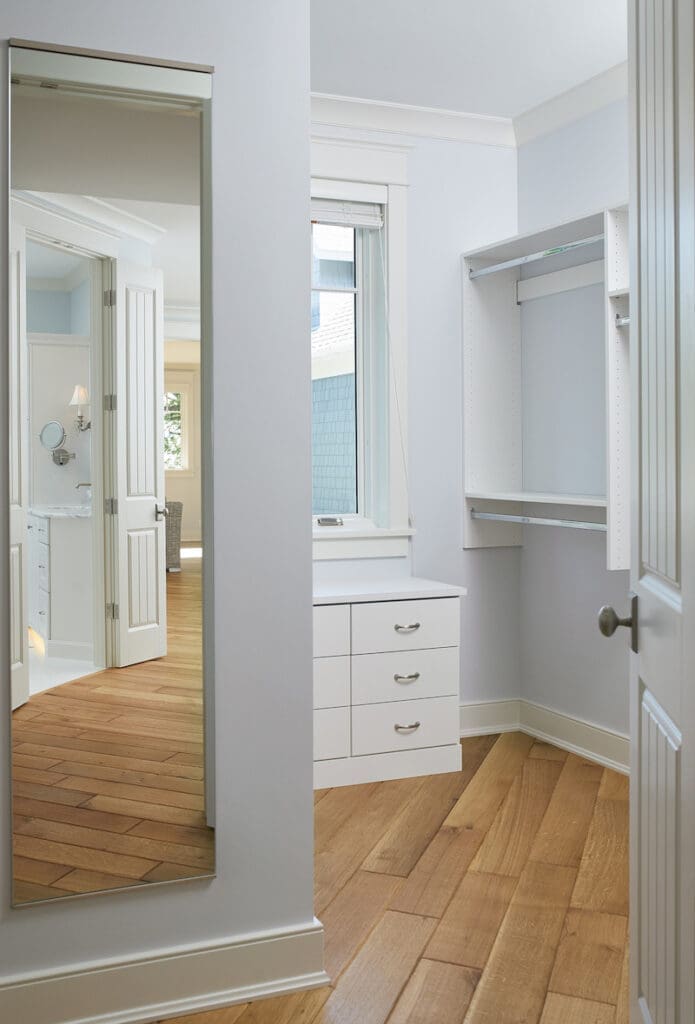 Hallway view into a spare bedroom walk-in closet conversion, now used as a personalized, stylish closet space.